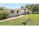 Inviting home featuring a lamp post, well-maintained lawn, and tasteful landscaping at 338 Eastern Ave, St Cloud, FL 34769