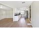 Modern kitchen with white cabinetry, stainless steel refrigerator, and black countertops at 338 Eastern Ave, St Cloud, FL 34769