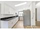 Modern kitchen featuring stainless steel appliances, white cabinets, and black countertops at 338 Eastern Ave, St Cloud, FL 34769