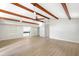 Open living space featuring exposed beams, ceiling fan, and sightlines to the kitchen at 338 Eastern Ave, St Cloud, FL 34769