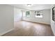 Bright, freshly painted living room with wood-look floors and sunlit windows at 338 Eastern Ave, St Cloud, FL 34769