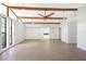 Bright, open living area with exposed beams, large windows, and access to kitchen at 338 Eastern Ave, St Cloud, FL 34769