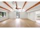 Bright living room with exposed wood beams, fan, and an abundance of natural light at 338 Eastern Ave, St Cloud, FL 34769