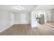 Open-concept living area with modern flooring flowing into kitchen at 338 Eastern Ave, St Cloud, FL 34769