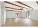 Open-concept living room featuring high ceilings with beams and large windows at 338 Eastern Ave, St Cloud, FL 34769