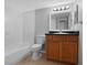 Clean bathroom featuring a shower-tub, toilet, and wood vanity with neutral tile flooring at 351 Lone Hill Dr # 206, Altamonte Springs, FL 32701