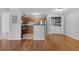 Kitchen with stainless steel appliances, wood cabinetry, and laundry area at 351 Lone Hill Dr # 206, Altamonte Springs, FL 32701