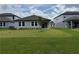 Well-maintained backyard features lush green lawn and a covered patio at 368 Birkdale Dr, Daytona Beach, FL 32124