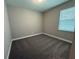 Comfortable bedroom featuring neutral walls, plush carpet, and a window that brings in natural light at 368 Birkdale Dr, Daytona Beach, FL 32124
