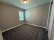 Comfortable bedroom features neutral walls, plush carpet, and a window that brings in natural light at 368 Birkdale Dr, Daytona Beach, FL 32124