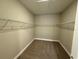 Walk-in closet with wall-mounted shelving and plush carpeting for optimal storage at 368 Birkdale Dr, Daytona Beach, FL 32124