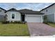 Charming single-story home features a paved driveway, manicured lawn, and attached garage at 368 Birkdale Dr, Daytona Beach, FL 32124