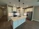 Bright kitchen boasts a large island, stainless appliances, modern lighting and ample counter space at 368 Birkdale Dr, Daytona Beach, FL 32124