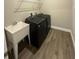 Modern laundry room with front loading washer and dryer, convenient utility sink at 368 Birkdale Dr, Daytona Beach, FL 32124