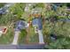 Aerial view of the home's layout on a verdant lot with mature tree coverage at 39939 Parkinsonia St, Lady Lake, FL 32159