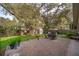 Brick patio area in a private backyard is ideal for outdoor entertaining and relaxing at 39939 Parkinsonia St, Lady Lake, FL 32159