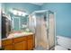 Bathroom featuring a glass-enclosed shower, a marble vanity, and a modern sink fixture at 39939 Parkinsonia St, Lady Lake, FL 32159