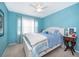 Cozy bedroom featuring a white bed frame, blue walls, and a ceiling fan for added comfort at 39939 Parkinsonia St, Lady Lake, FL 32159