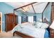 Main bedroom boasts a four poster bed, neutral carpet, and large wardrobe at 39939 Parkinsonia St, Lady Lake, FL 32159