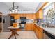 Spacious kitchen featuring stainless steel appliances, granite counters and wood cabinets at 39939 Parkinsonia St, Lady Lake, FL 32159
