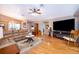 Living area with hardwood floors, plenty of seating, and an open floor plan at 39939 Parkinsonia St, Lady Lake, FL 32159