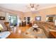 Open living room boasts hardwood floors, recessed lighting and access to screened in patio at 39939 Parkinsonia St, Lady Lake, FL 32159