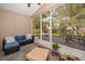 Screened-in patio with comfortable seating offers a relaxing view of the backyard at 39939 Parkinsonia St, Lady Lake, FL 32159