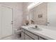 Bright bathroom featuring a toilet, vanity, and decorative wallpaper at 4026 S Lake Orlando Pkwy, Orlando, FL 32808