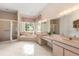 Ensuite bathroom featuring double sinks, walk-in shower, and garden tub at 4026 S Lake Orlando Pkwy, Orlando, FL 32808