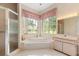 Bright bathroom featuring a walk-in shower, tub, and large window at 4026 S Lake Orlando Pkwy, Orlando, FL 32808