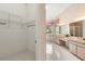 Ensuite bathroom with double vanity, tub, walk-in shower, and walk-in closet at 4026 S Lake Orlando Pkwy, Orlando, FL 32808