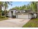 Charming single-Gathering home with a two-car garage and landscaped front yard and concrete driveway at 4026 S Lake Orlando Pkwy, Orlando, FL 32808