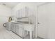 Functional laundry room with washer, dryer, utility sink, and ample storage at 4026 S Lake Orlando Pkwy, Orlando, FL 32808