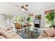 Cozy living room with a ceiling fan, sliding glass doors, and large windows at 4026 S Lake Orlando Pkwy, Orlando, FL 32808