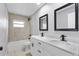 Modern bathroom with double vanity, black fixtures, and a shower-tub combo at 4116 Sw 20Th St, Ocala, FL 34474