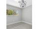 Bedroom featuring a window, light-colored floors and a modern chandelier at 4116 Sw 20Th St, Ocala, FL 34474