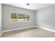 Bright room featuring updated floors, neutral paint, and a large window at 4116 Sw 20Th St, Ocala, FL 34474