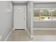 Bright entryway featuring wood-look tile flooring and a decorative front door with sidelight window at 4116 Sw 20Th St, Ocala, FL 34474