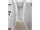 Hallway with hard floors and white trim leading to different rooms in the house at 4116 Sw 20Th St, Ocala, FL 34474
