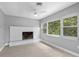 Bright living room featuring a painted brick fireplace and large windows at 4116 Sw 20Th St, Ocala, FL 34474