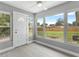 Sunroom with large windows, door, and light colored flooring overlooking the backyard at 4116 Sw 20Th St, Ocala, FL 34474
