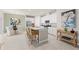 Open-concept kitchen with modern appliances, granite countertops, and dining area at 427 Shoreview Sands Ave, Mascotte, FL 34753