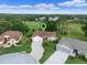 Aerial view showcasing the property's location with a locator pin within a golf course community at 4830 Summerbridge Cir, Leesburg, FL 34748