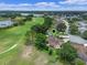 Aerial view showing property with location pin in a golf community, surrounded by trees and lush landscaping at 4830 Summerbridge Cir, Leesburg, FL 34748