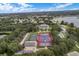 Aerial view showcasing tennis courts, a swimming pool, and the community clubhouse at 4830 Summerbridge Cir, Leesburg, FL 34748