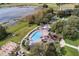 Expansive aerial view showcases the pool, water feature, clubhouse, and surrounding landscape at 4830 Summerbridge Cir, Leesburg, FL 34748