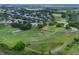 Scenic aerial view of a golf course community highlighting lush greenery and surrounding residential homes at 4830 Summerbridge Cir, Leesburg, FL 34748