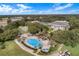 Expansive aerial view showcases the pool, water feature, clubhouse, and surrounding landscape at 4830 Summerbridge Cir, Leesburg, FL 34748