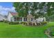 Large backyard with a patio, manicured lawn, and established landscaping at 4830 Summerbridge Cir, Leesburg, FL 34748