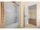 Bathroom featuring a shower-tub combo with tile surround, and neutral color palette at 4830 Summerbridge Cir, Leesburg, FL 34748